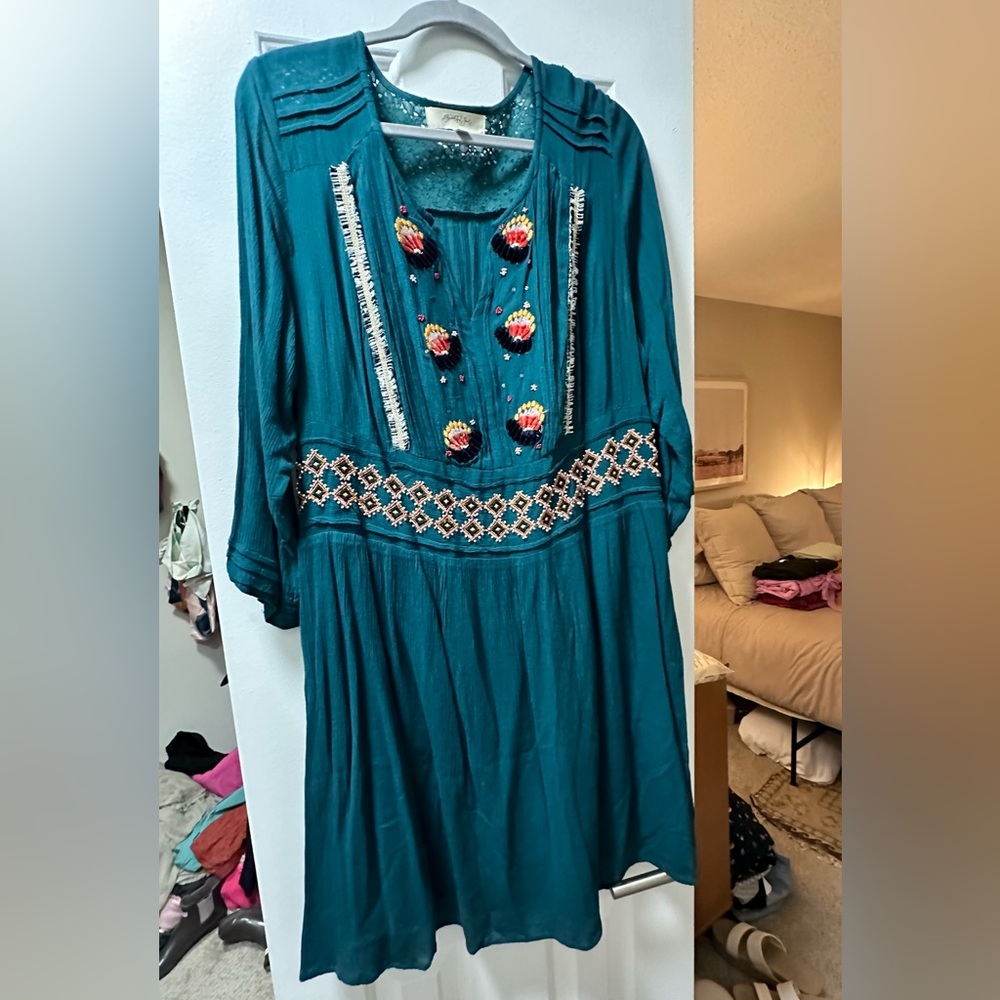 Turquoise dress with appliqué design